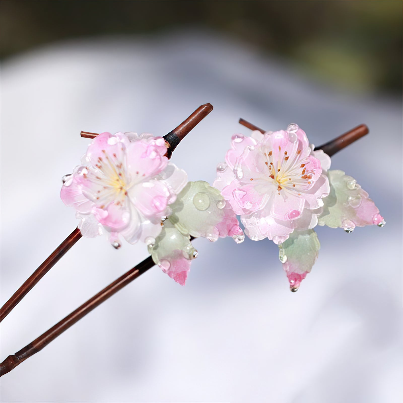 Close-up of engraved petals and warm wooden shaft held against a hand