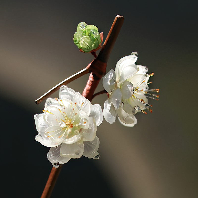Side view showing slender wooden stick with blossom motif securing half-up hairstyle