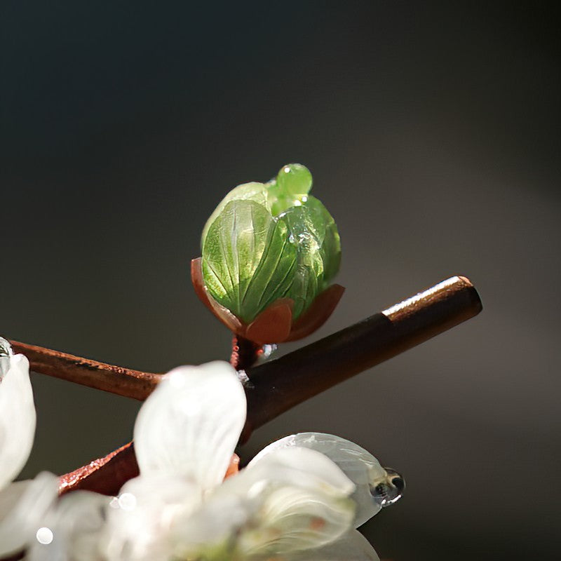 Model wearing the hair stick in an elegant bun, floral accent front-facing