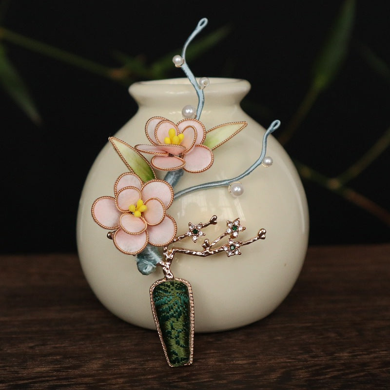 Side view showing butterfly-inspired curve and pearled cluster on garment