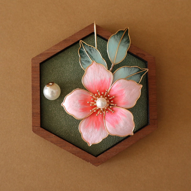 Model wearing brooch on coat lapel, butterfly accent placed near shoulder