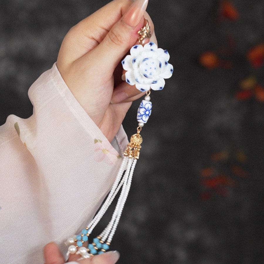 Enamel-accent layered petals with central pearl shown on wool coat