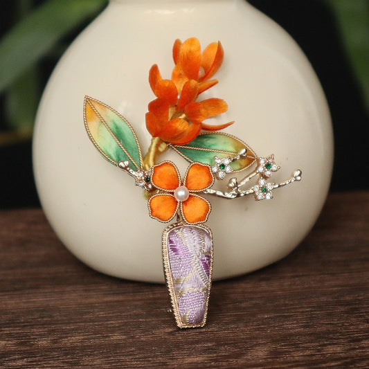 purple velvet vase-inspired brooch on dark fabric