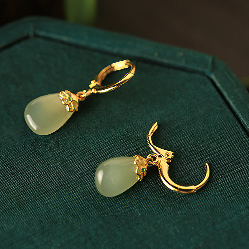 Green jade pendants earrings, worn styling view