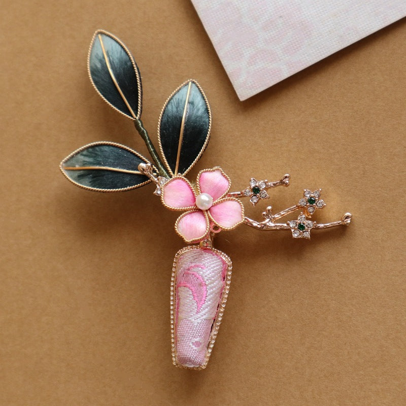 floral vase-inspired brooch pin on a dress