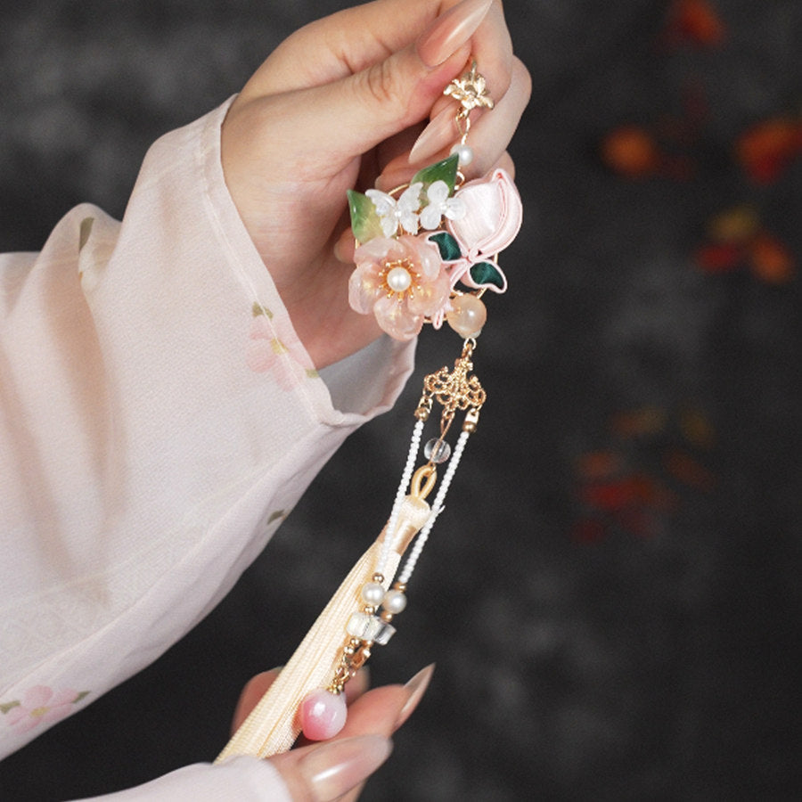 peach blossom Hanfu brooch with tassel detail styled for an occasion
