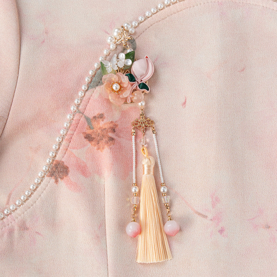 peach blossom Hanfu brooch with tassel detail viewed close up