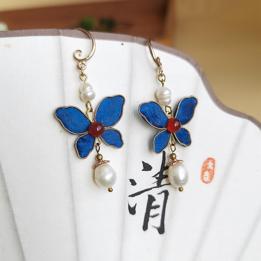 Butterfly and pearl drops earrings, front view
