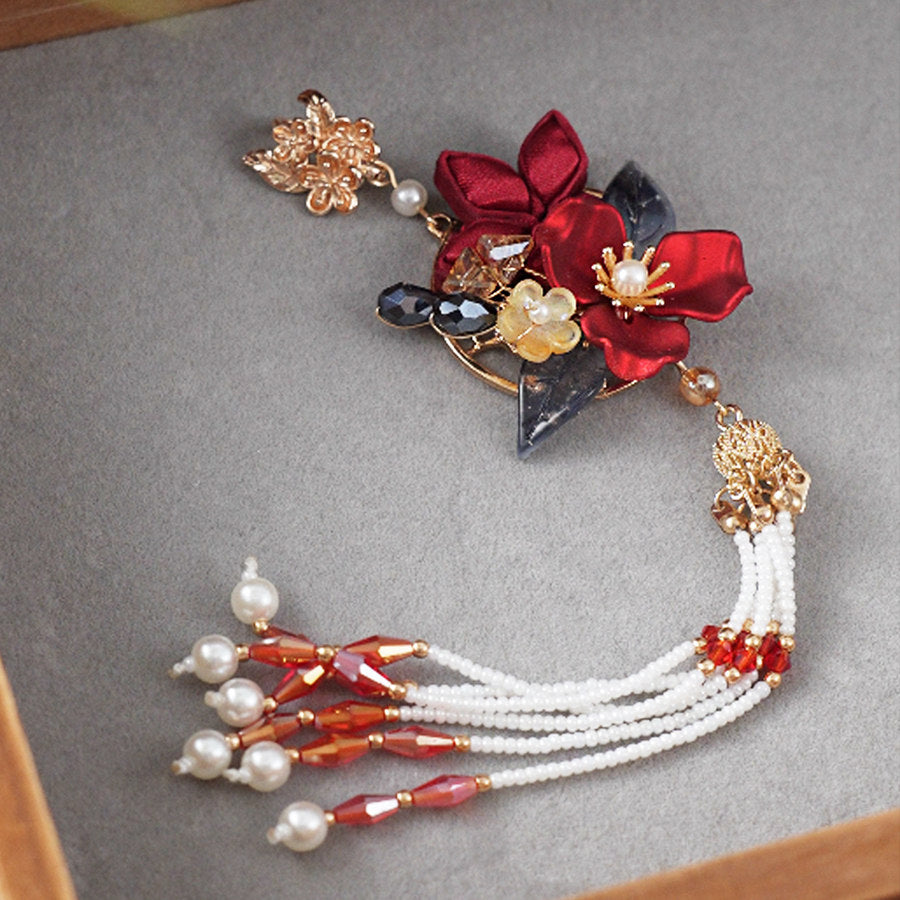 traditional brooch pin styled on Hanfu displayed on fabric