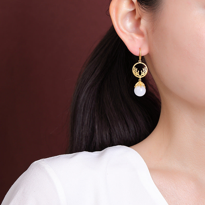 Openwork jade-style drops earrings, close detail