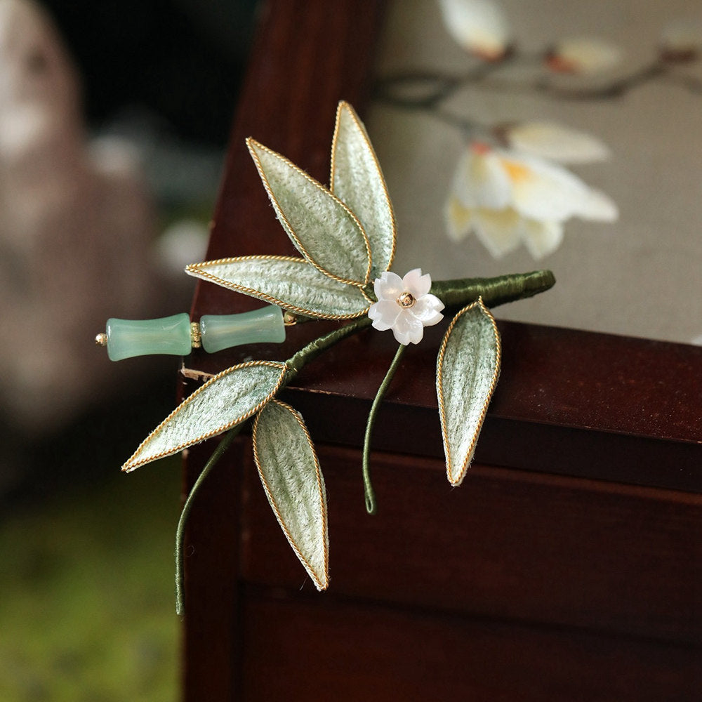 brooch pinned to a wooden frame display, warm tones and styling idea