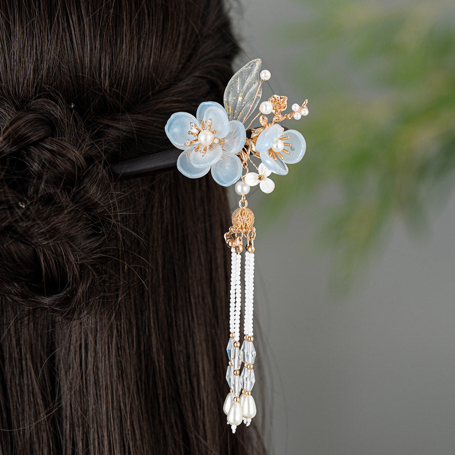 Model wearing hair stick in a low bun with floral accent