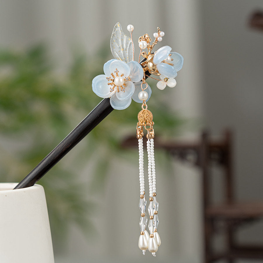 Close-up of blue blossom detail and fine tassel on stick