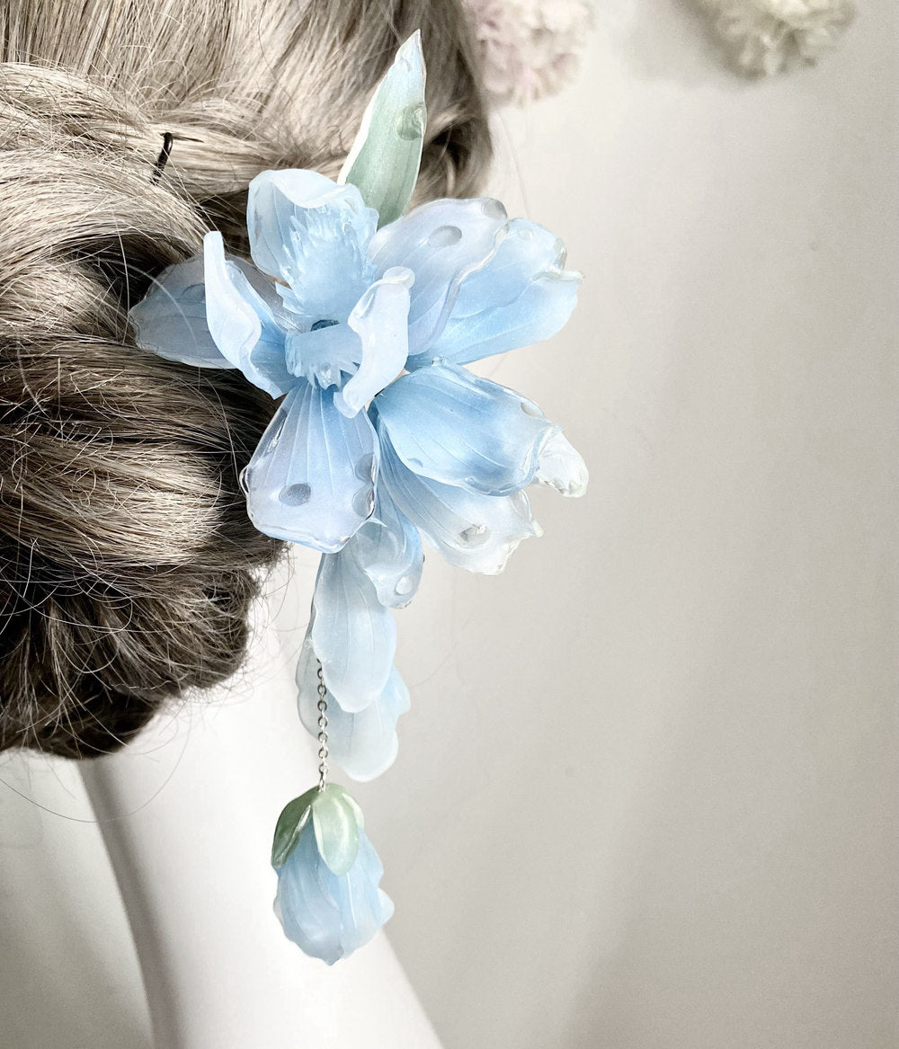 Close-up of iris-inspired floral detail attached near the pin's head