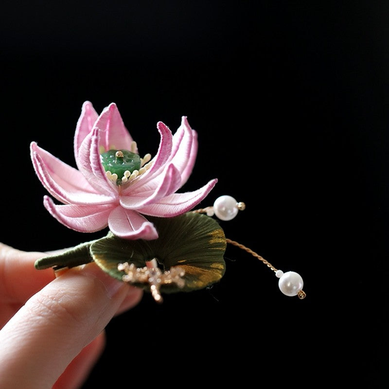 Front view of lotus-inspired pin with matte gold finish against white