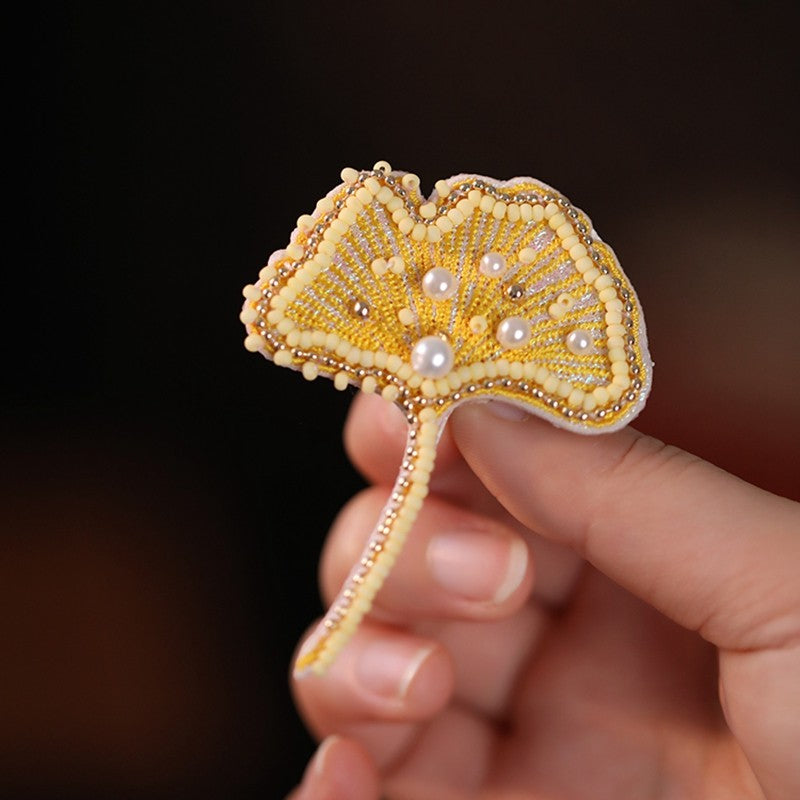 Back of brooch showing metal pin clasp and curved fastening bar