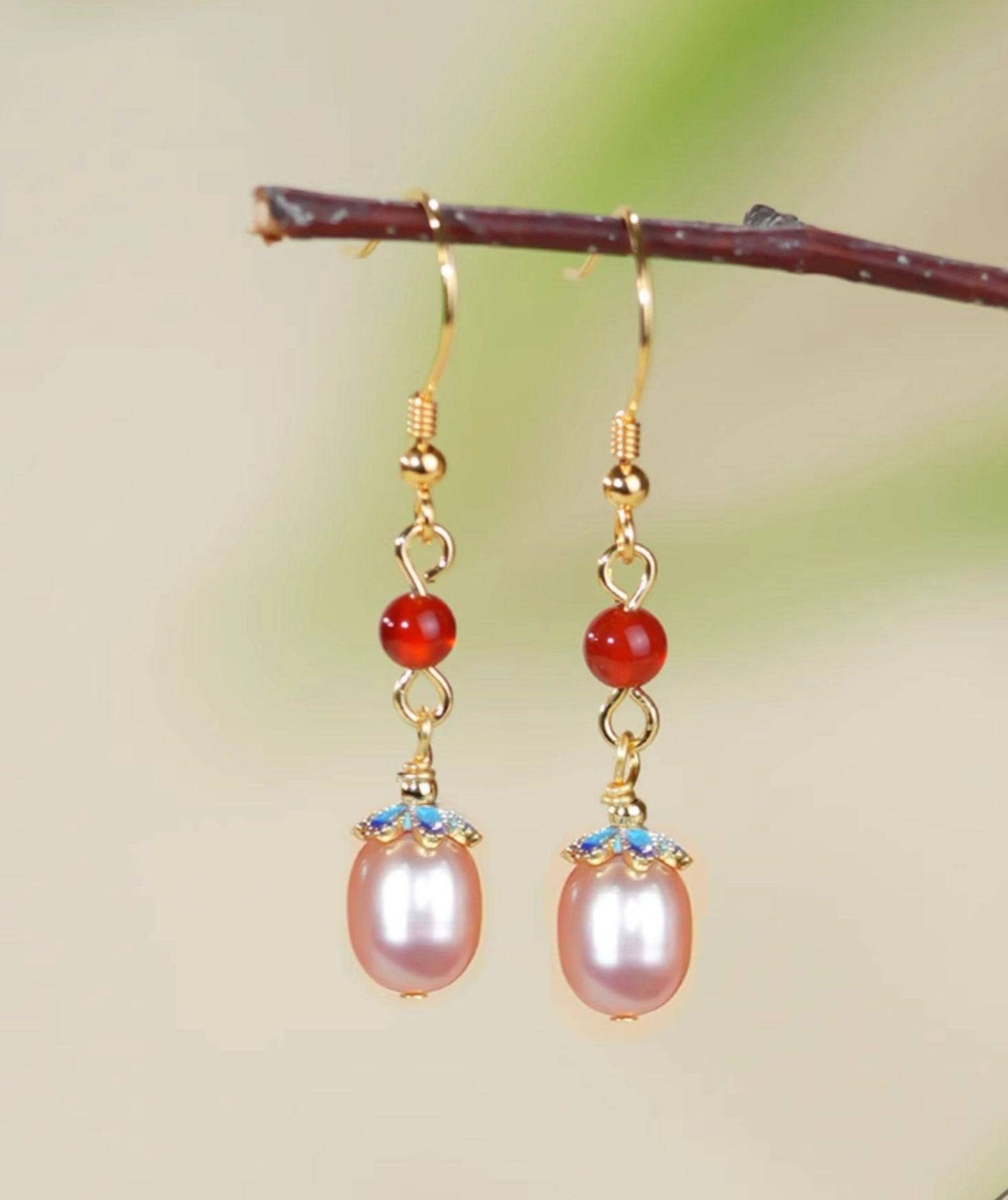 Red stone and pearl drops earrings, side profile