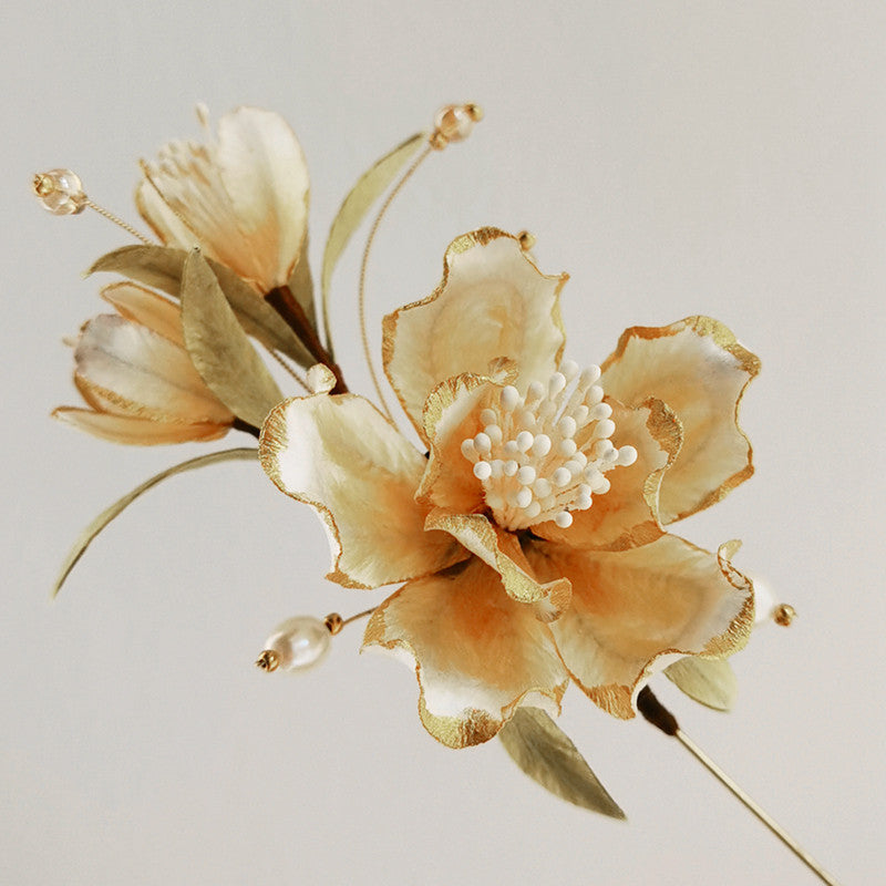 Ronghua-inspired Chinese flower brooch on Hanfu viewed close up