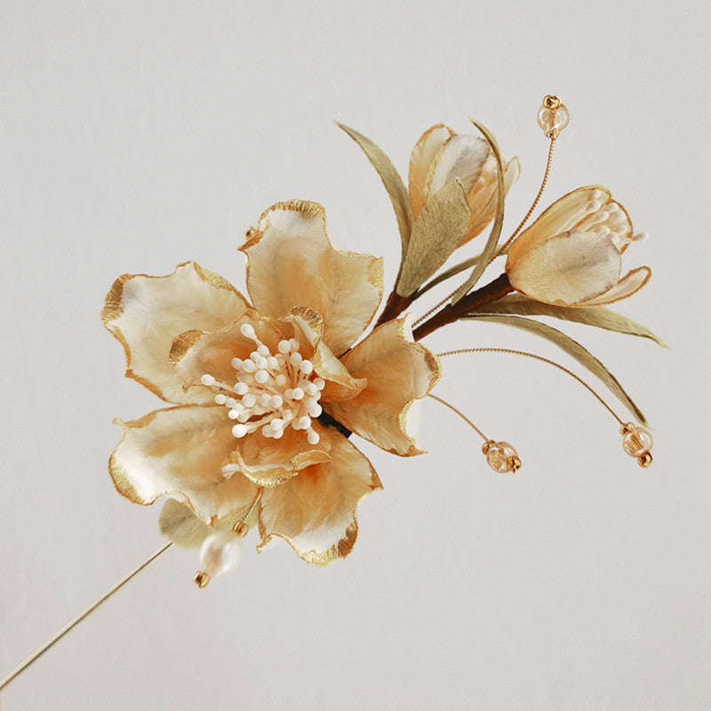 Ronghua-inspired Chinese flower brooch on Hanfu displayed on fabric