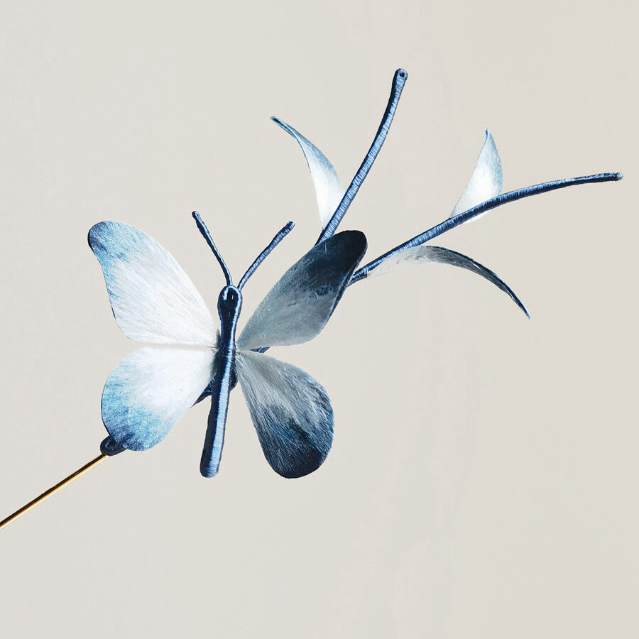 Close-up of sculpted blue wings showing delicate surface detail
