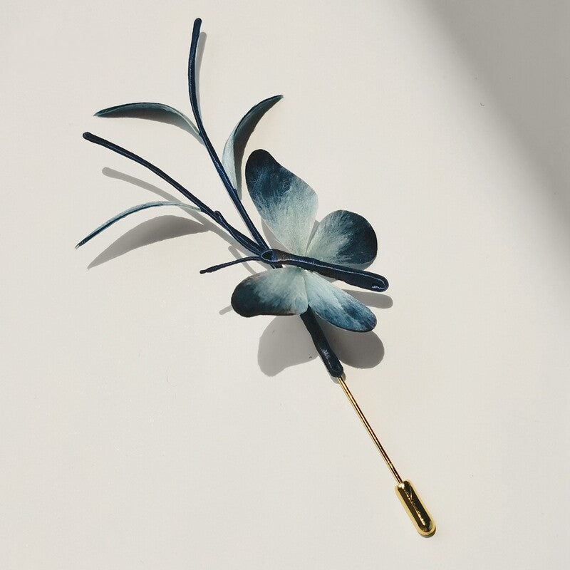 Full-length blue dragonfly brooch shown flat with long slender pin