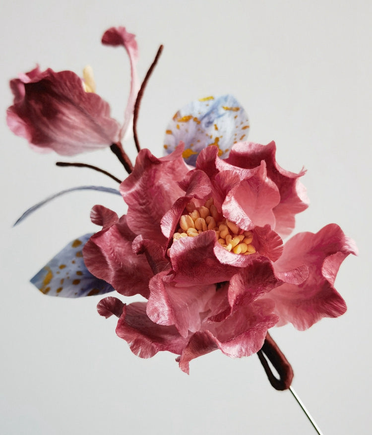 pink floral brooch pin with pearl drop on a coat styled for an occasion