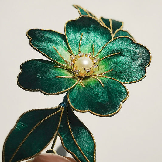 Close-up of the brooch center highlighting a pearl-like accent and textured petals