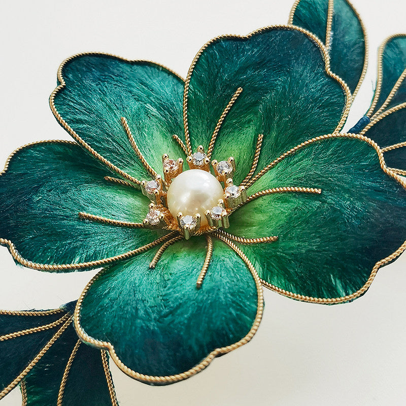 Detail shot of pearl-like center set within green petals, suited for coats or dresses