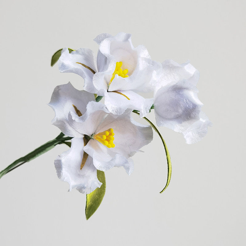white lily brooch pin on a wedding guest dress styled for an occasion