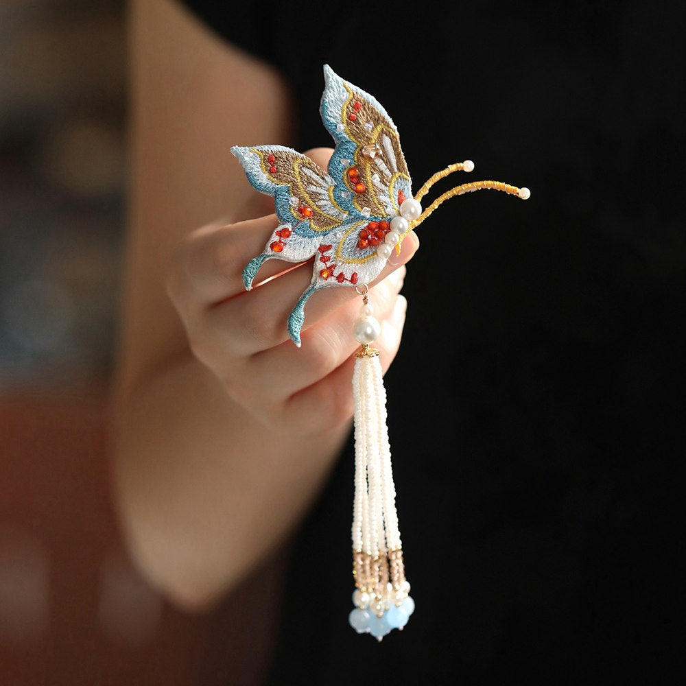 tassel butterfly brooch pin on a Qipao viewed close up