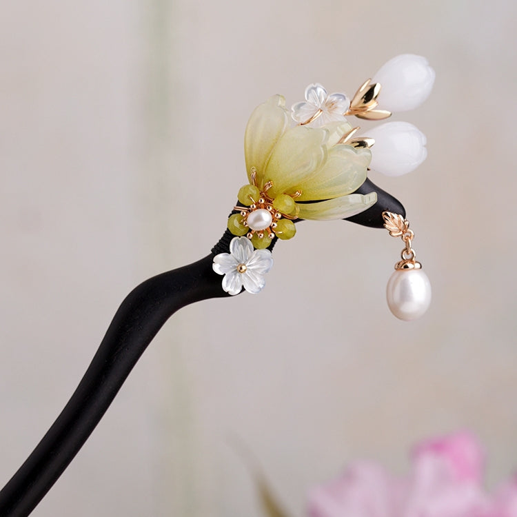 side view of dark wood hair stick showing slim profile and sheen