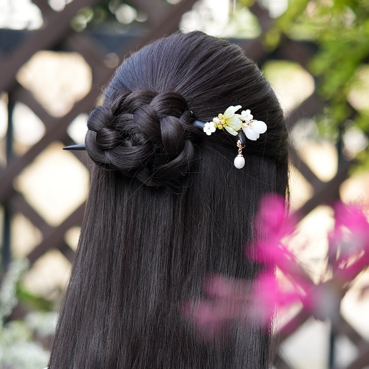 model wearing hairpin in elegant bun showcasing magnolia floral detail