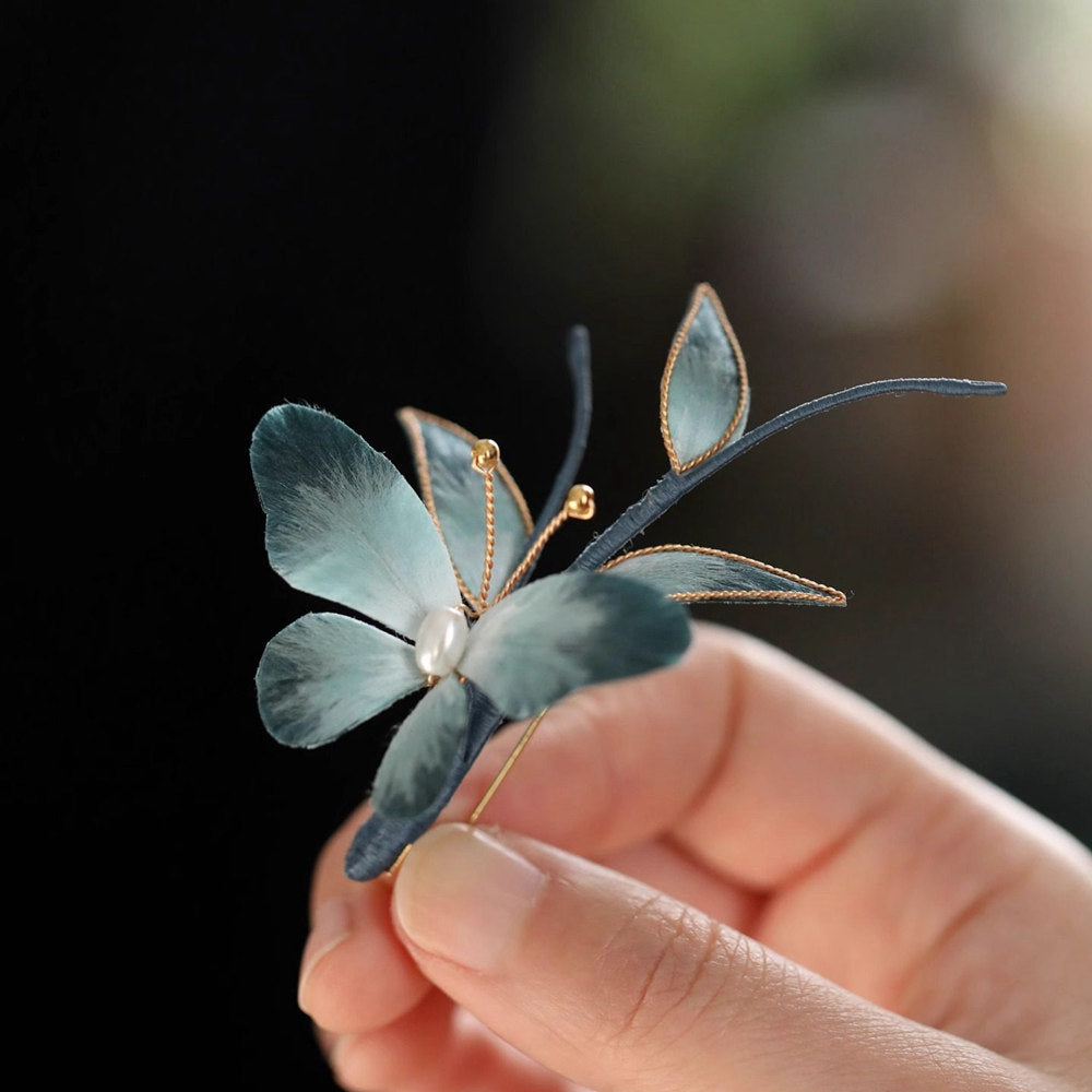 butterfly brooch on a winter coat displayed on fabric