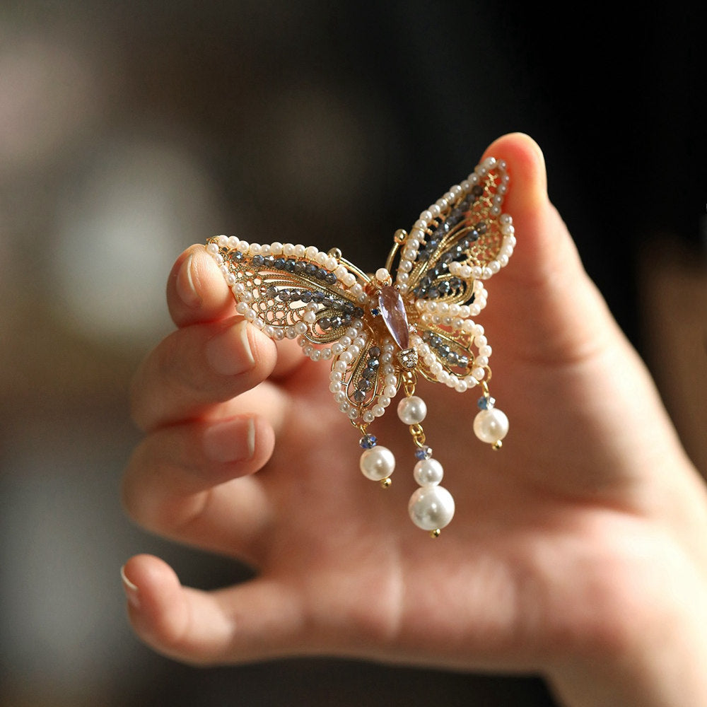 Lightweight butterfly brooch held in hand to show scale and finish
