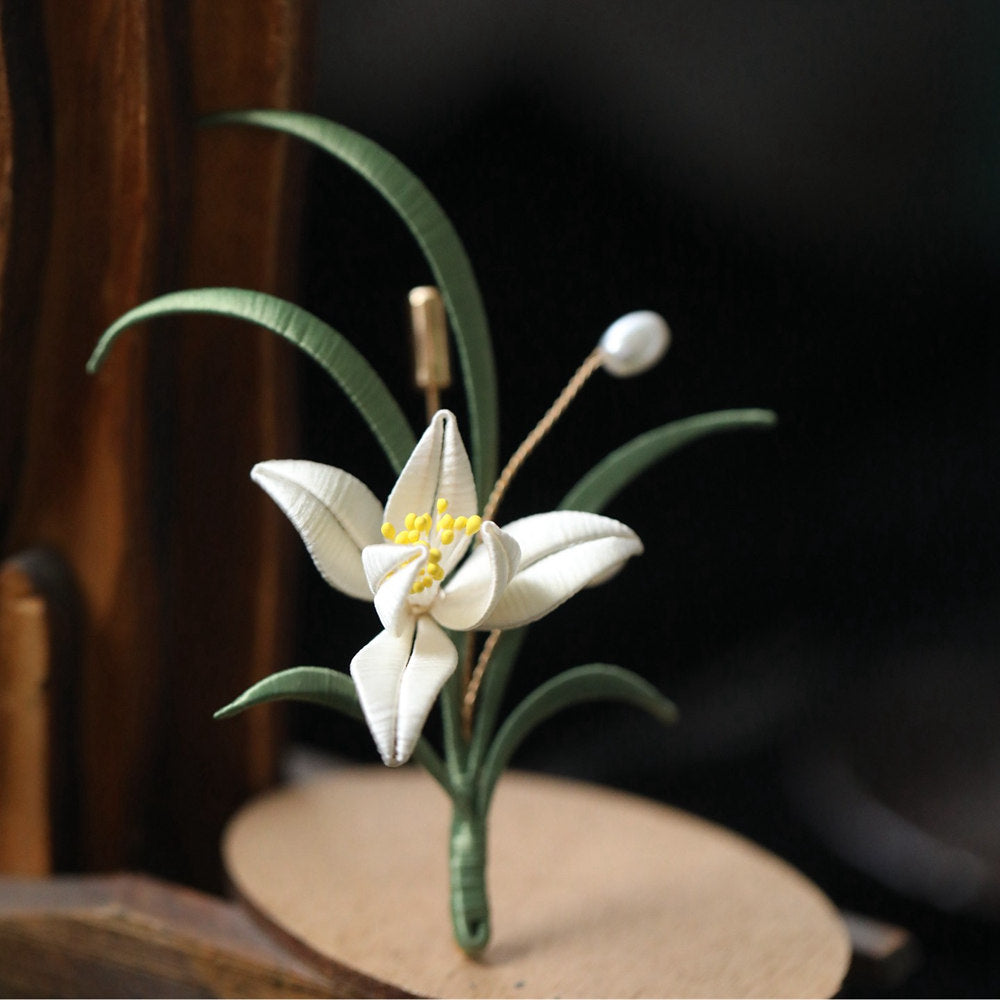 minimal orchid brooch pin styled on a cardigan