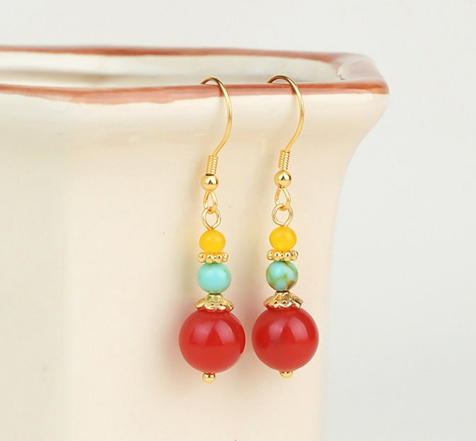 Zodiac-inspired statement earrings earrings, worn styling view