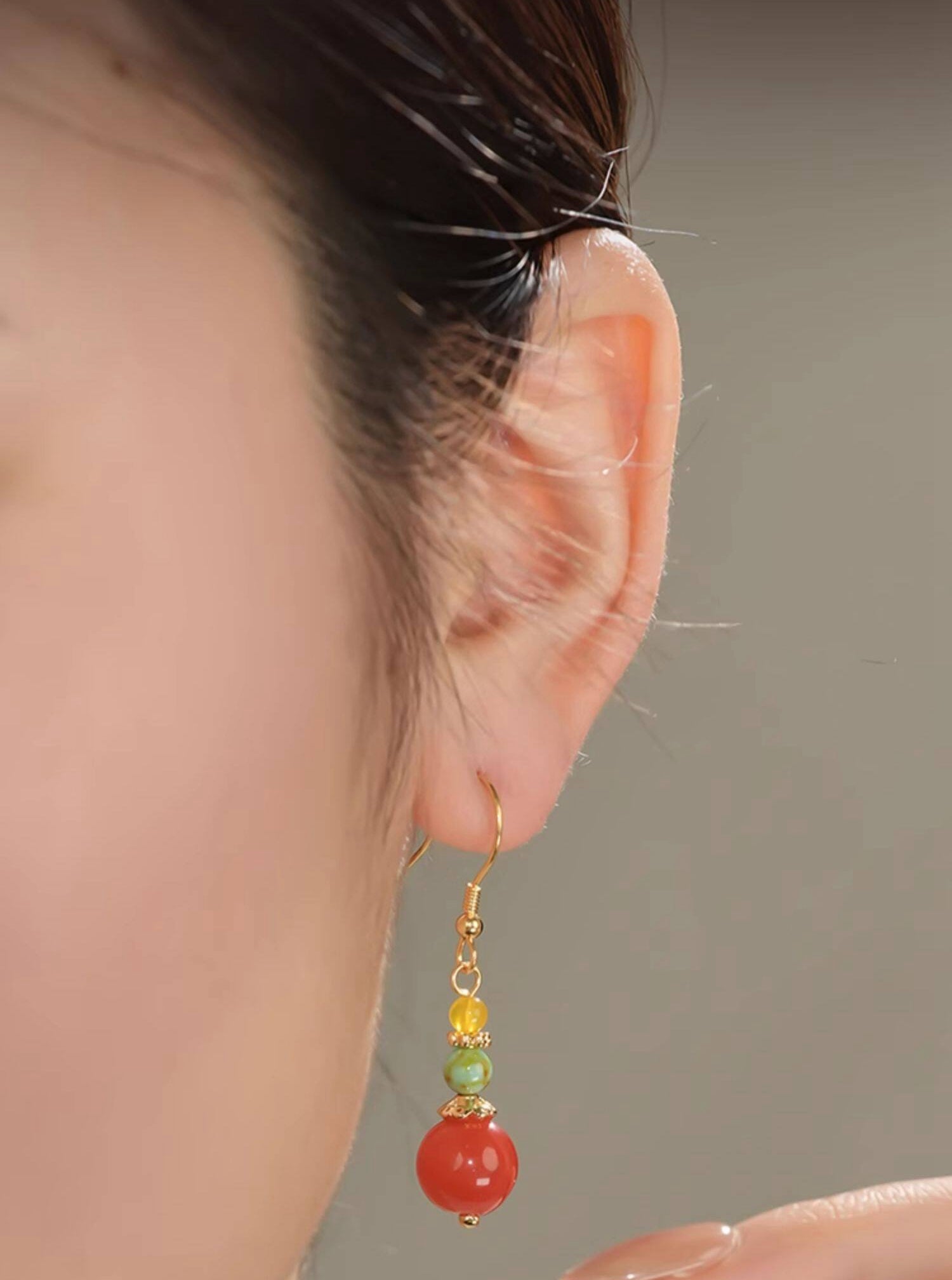 Zodiac-inspired statement earrings earrings, close detail