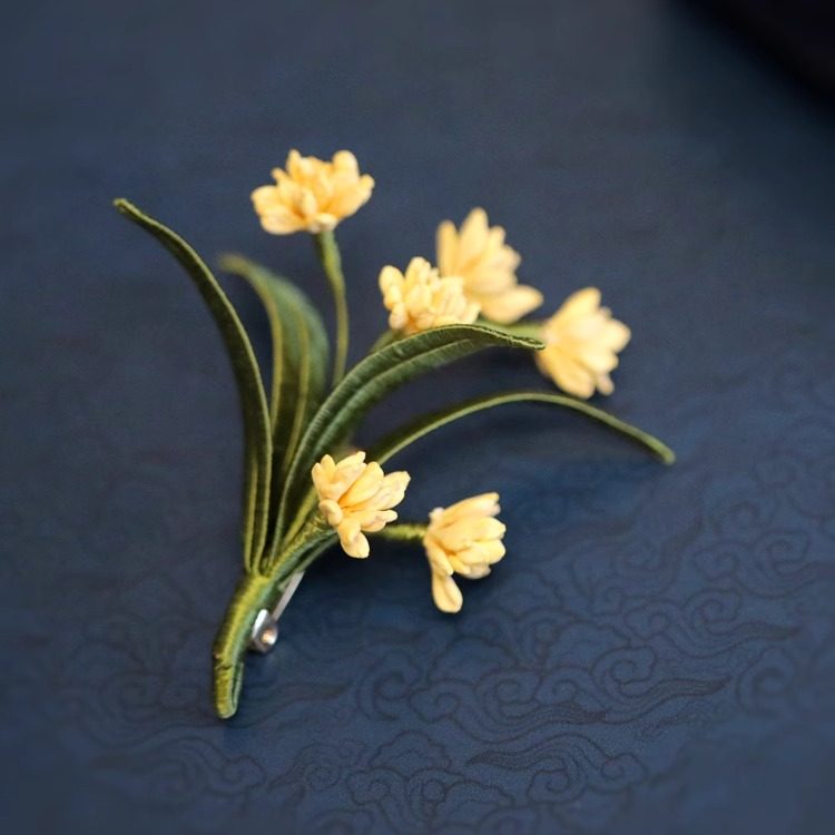 Flat lay on blue background highlighting layered petals and subtle sheen of metal
