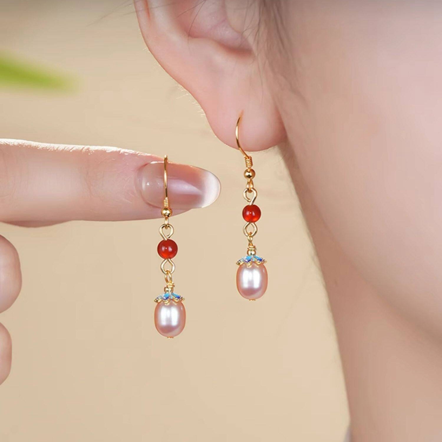 Red stone and pearl drops earrings, front view