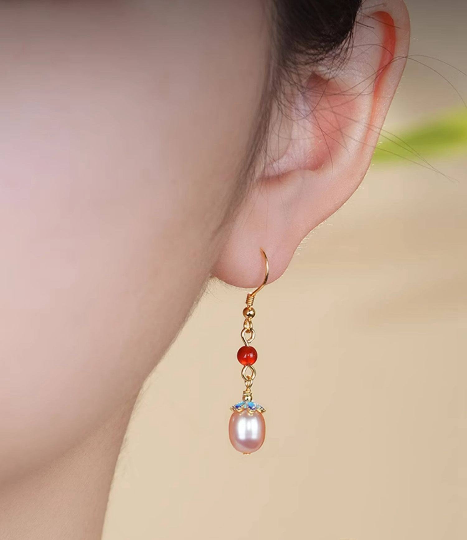 Red stone and pearl drops earrings, close detail
