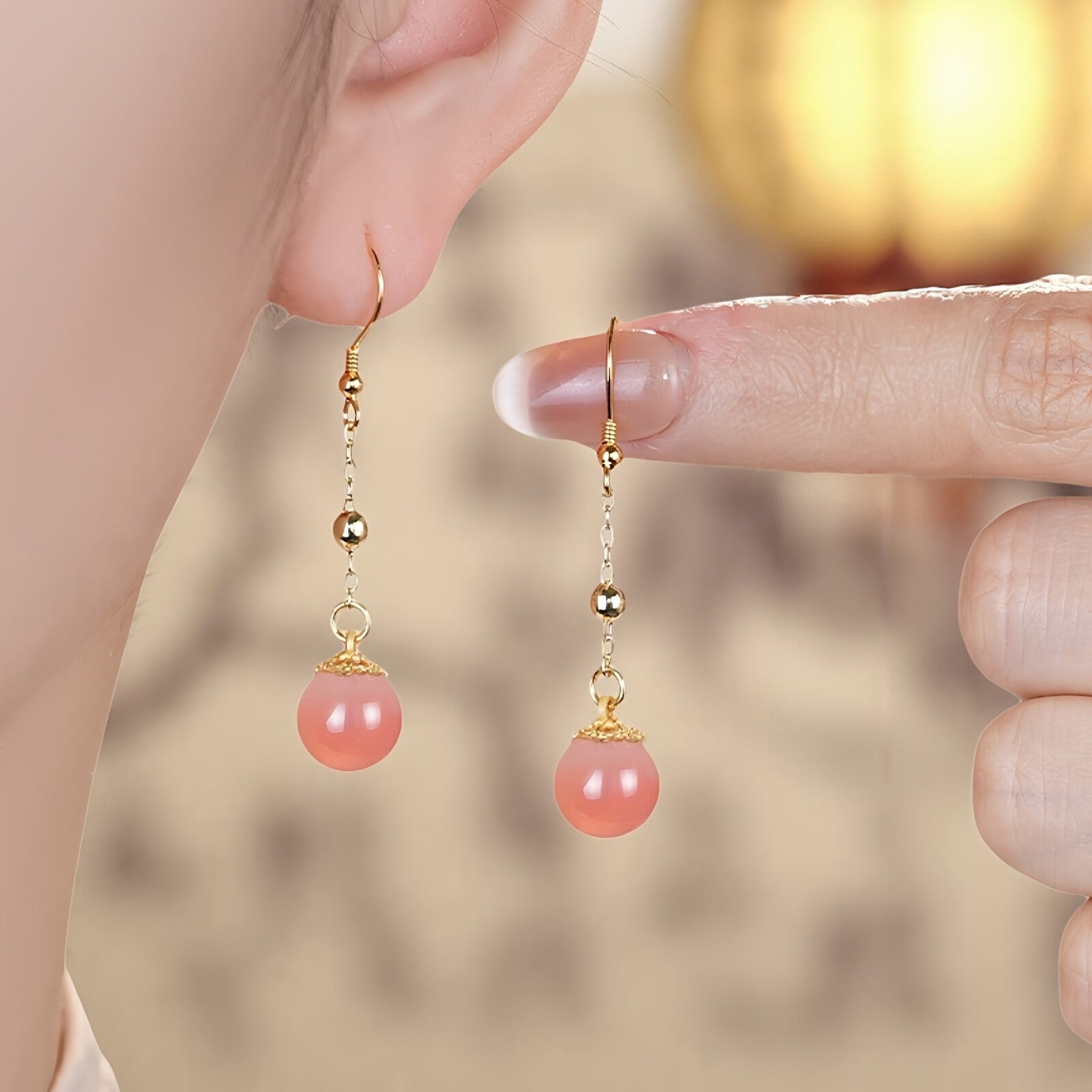Pink stone dangles earrings, front view