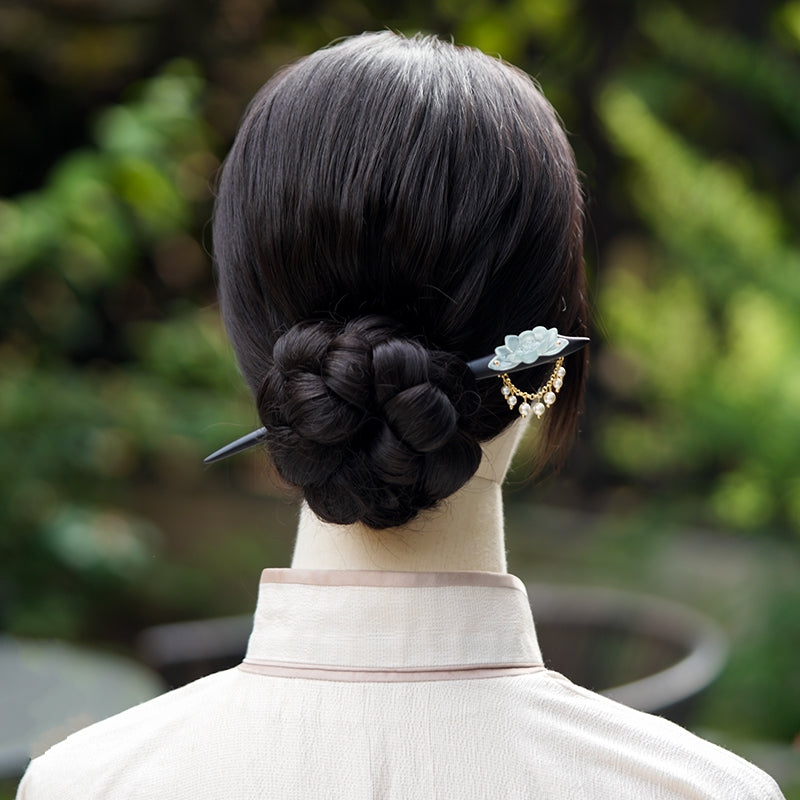 Hair stick secured in an elegant updo styled with flowing Hanfu fabric