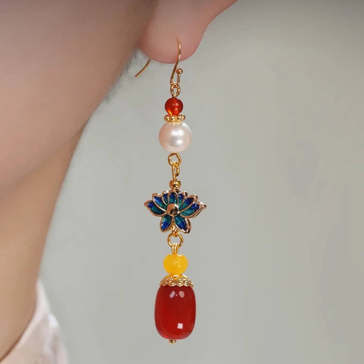 Blue lotus and red bead drops earrings, close detail