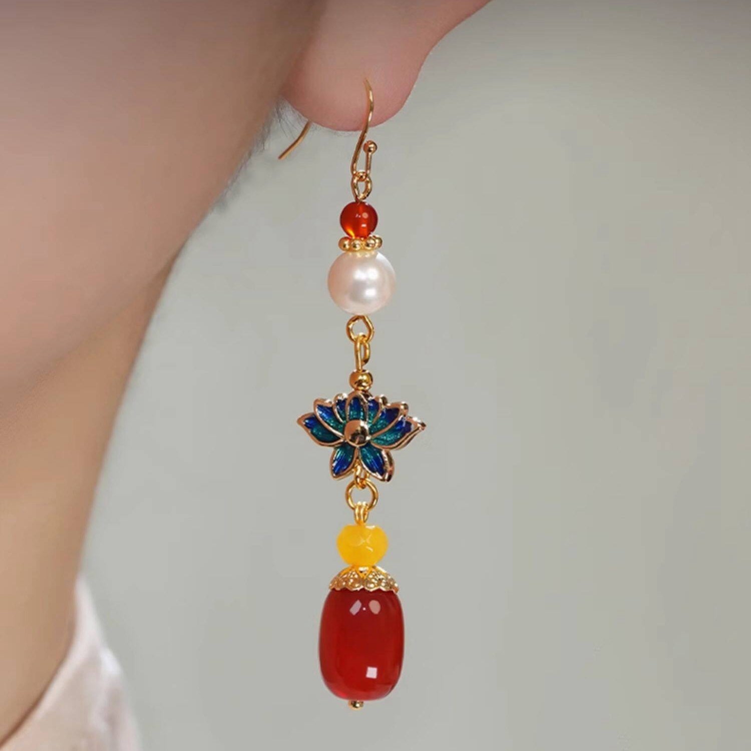 Blue lotus and red bead drops earrings, close detail