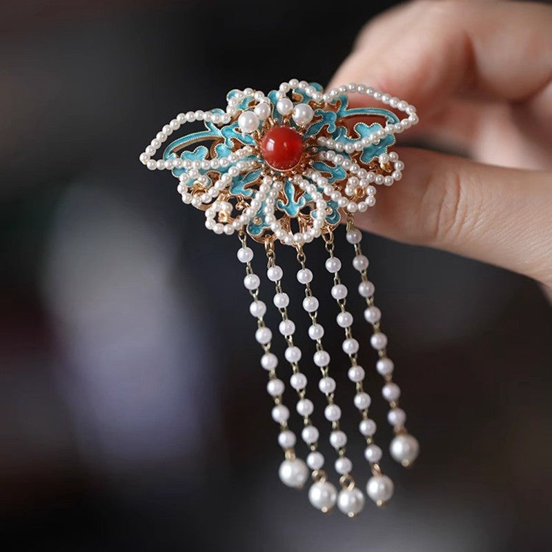 butterfly statement brooch with pearl drop detail styled for an occasion