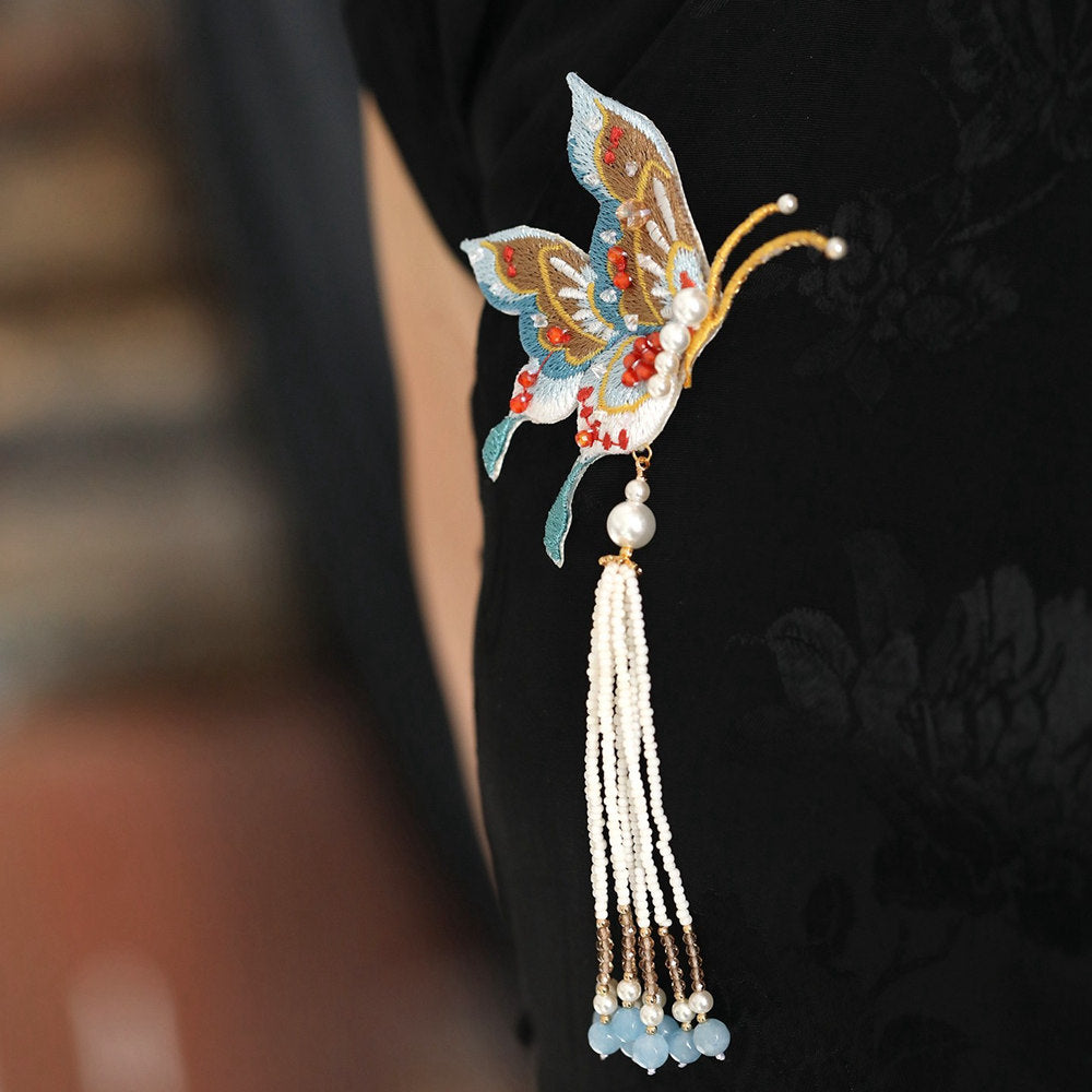 tassel butterfly brooch pin on a Qipao styled for an occasion