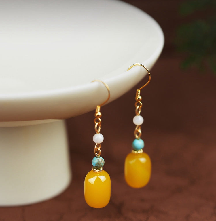 Yellow stone and pearl drops earrings, side profile