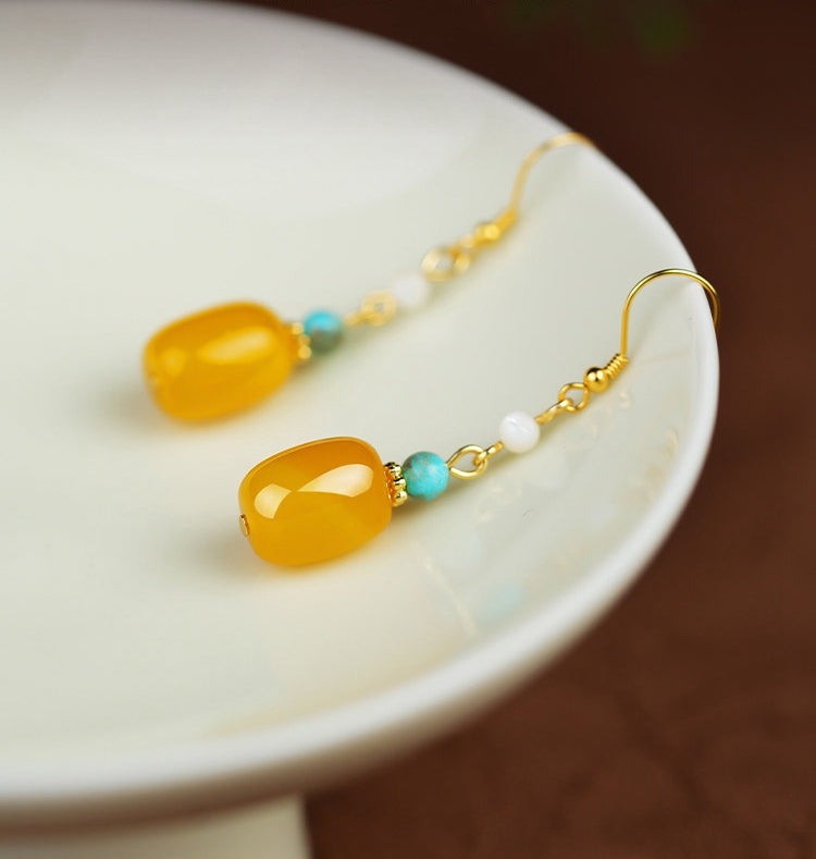 Yellow stone and pearl drops earrings, worn styling view
