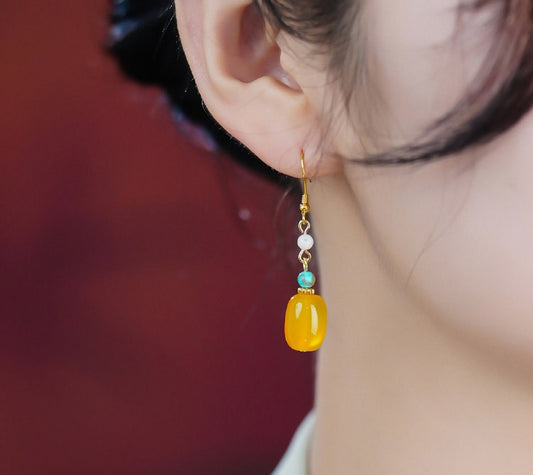 Yellow stone and pearl drops earrings, close detail